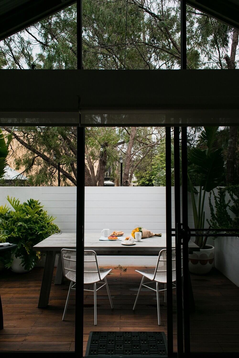 Terraza con mesa y sillas en blanco